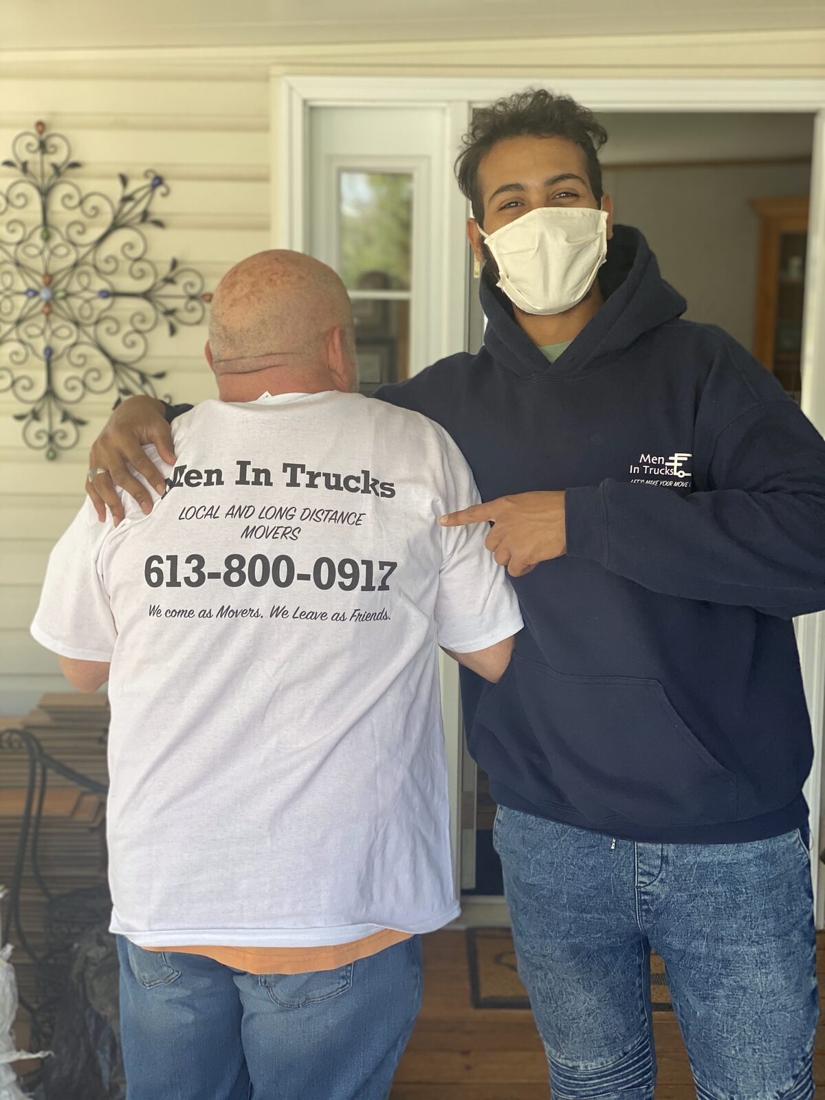 Men In Trucks movers in branded shirts at a customer home