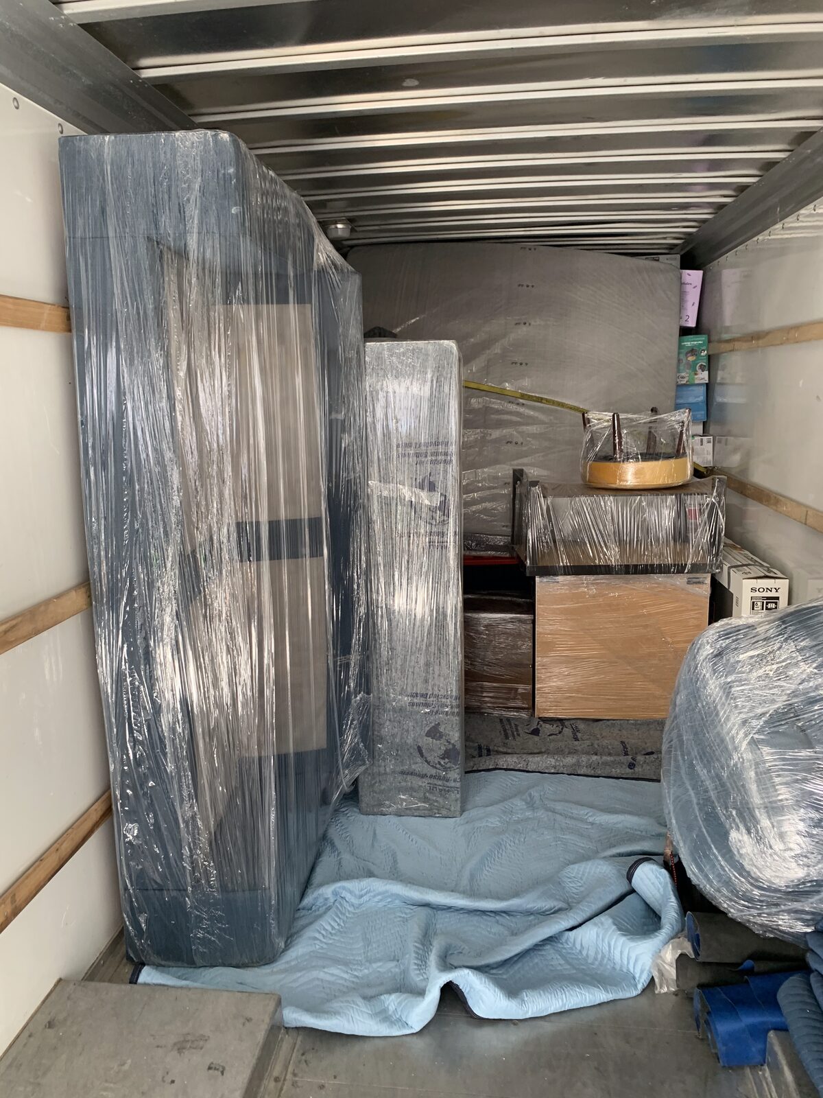 Furniture professionally loaded and wrapped inside a Men In Trucks truck
