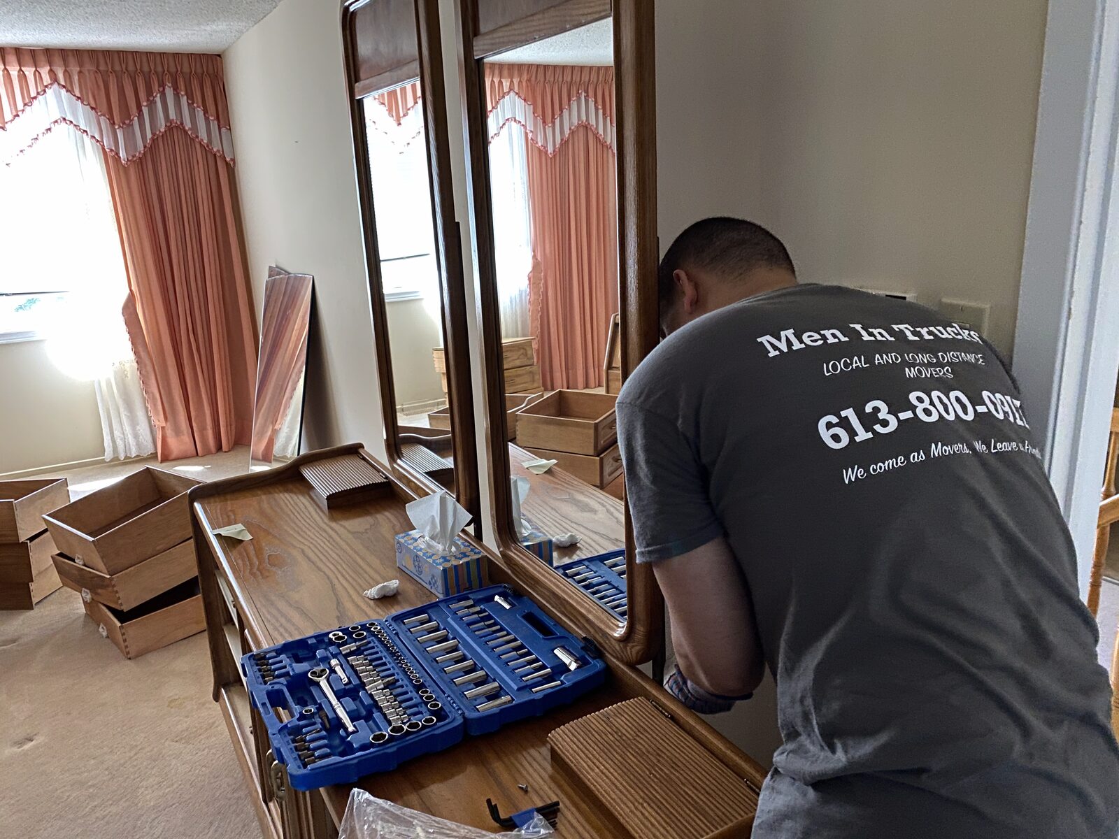 Men In Trucks mover disassembling furniture during a move
