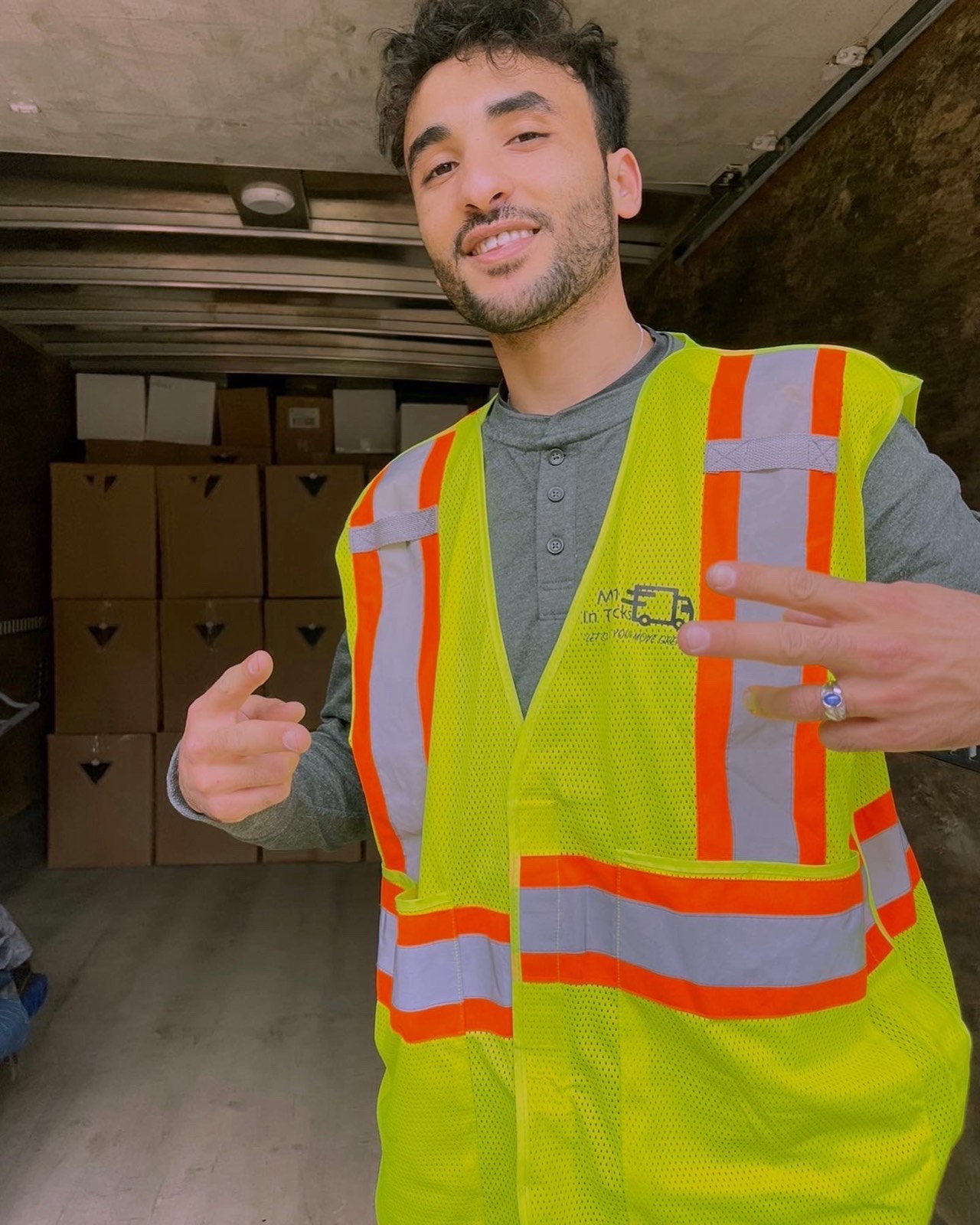 Friendly Men In Trucks mover in the truck with packed moving boxes in Ottawa