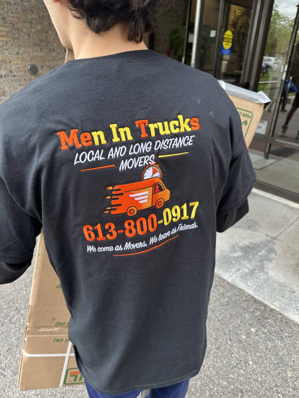 Men In Trucks mover carrying boxes during a residential move