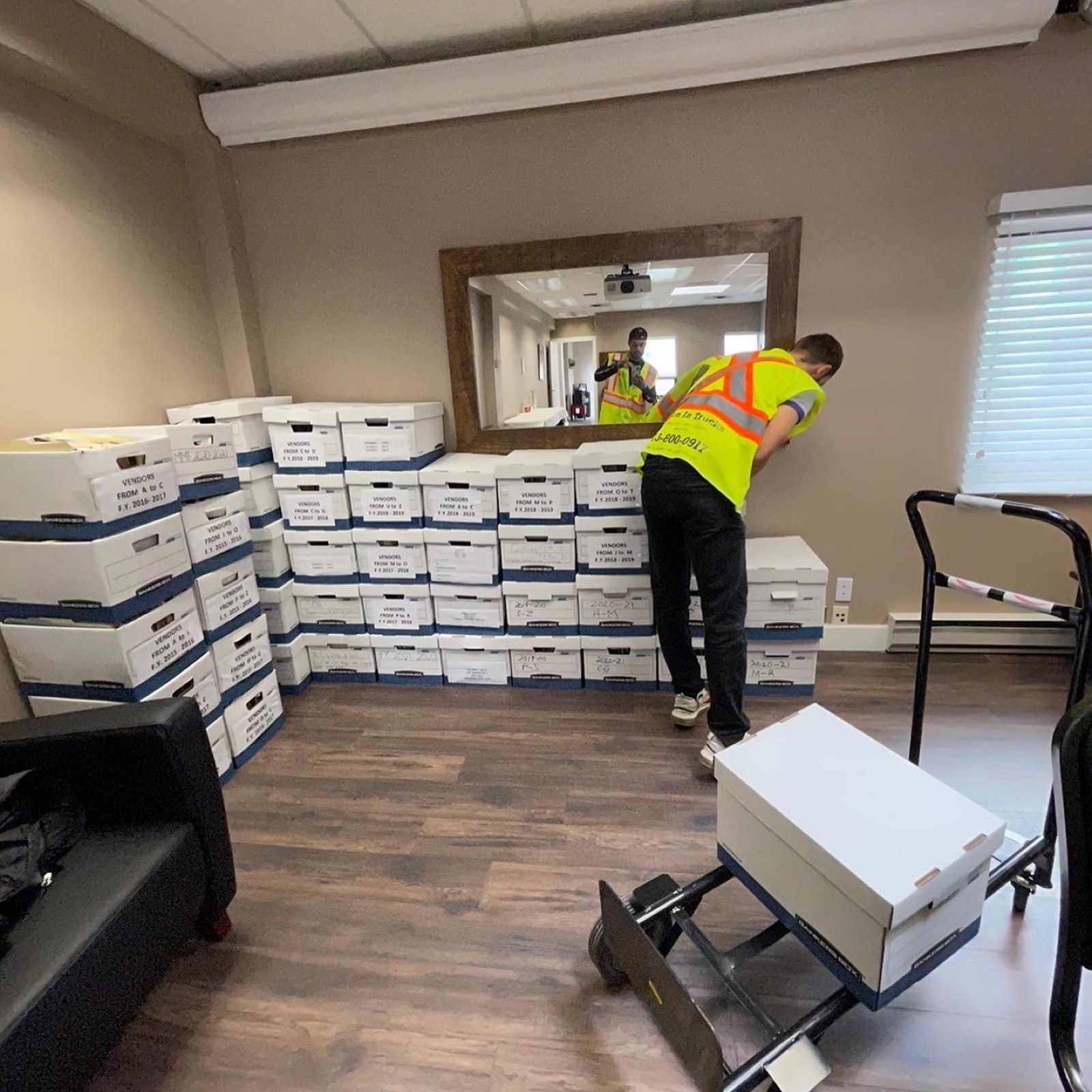 Men In Trucks movers staging labelled file boxes during an Ottawa office move