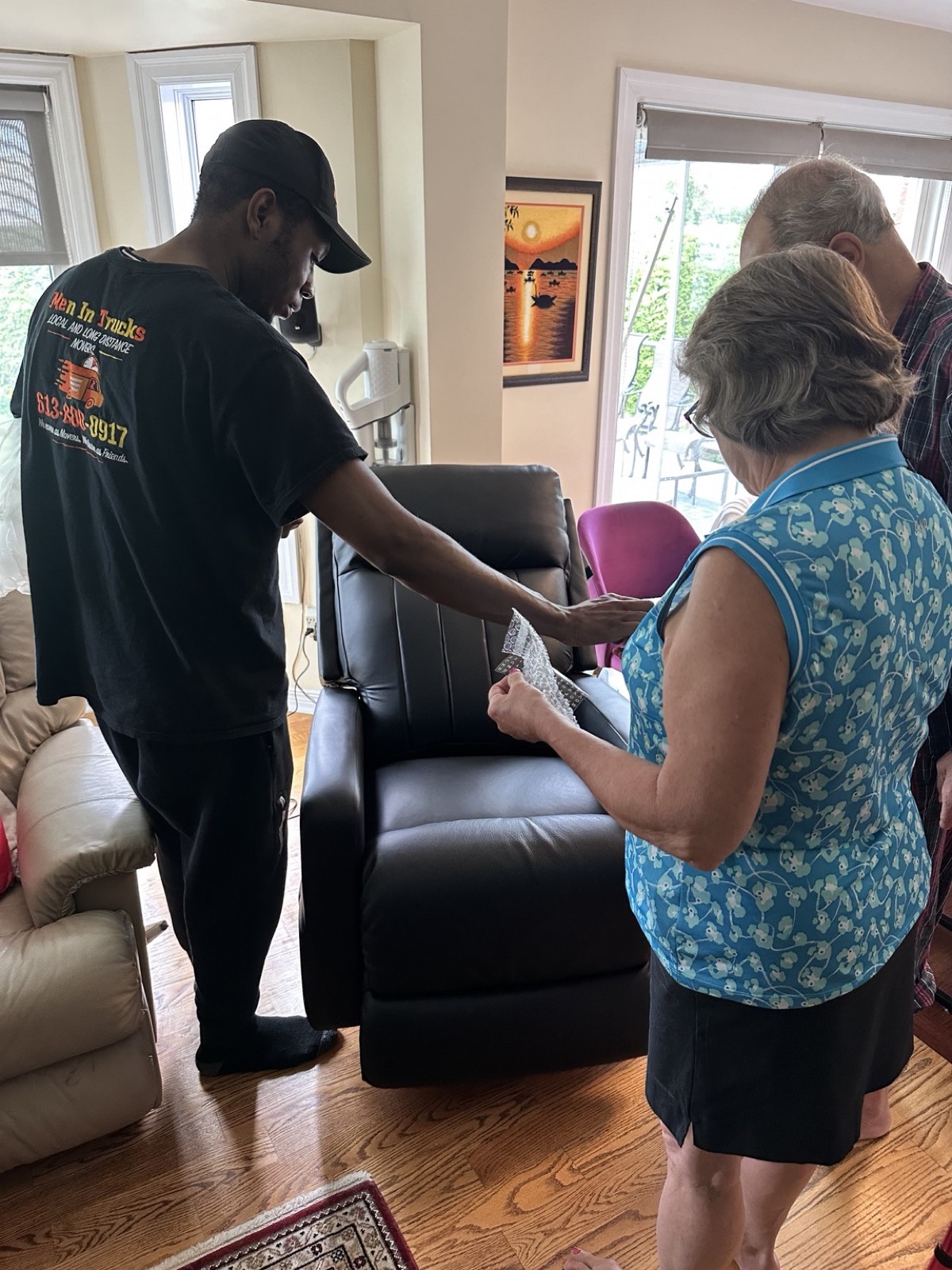 Men In Trucks mover completing a white-glove recliner delivery for a senior couple in Ottawa